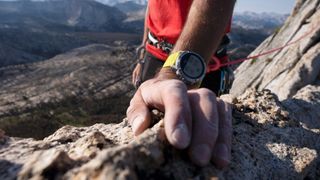 Man rock climbing wearing Coros Vertix 2 watch