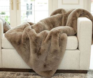 Cuddle Blanket on a white armchair.