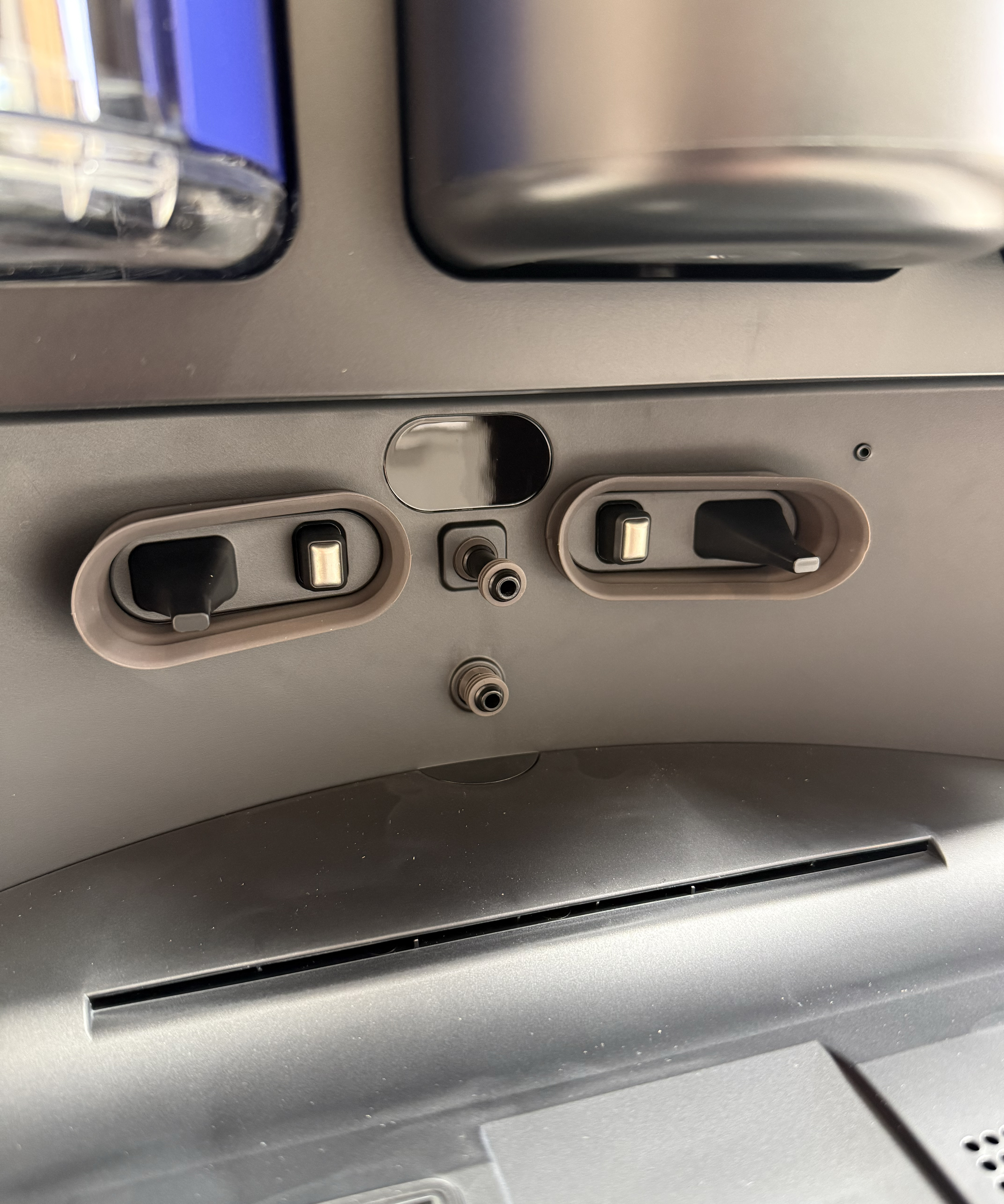 Close-up of the Dyson Spot+Scrub Ai dock showing charging contacts and water connection points