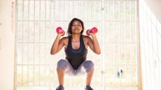 Woman performing a dumbbell squat
