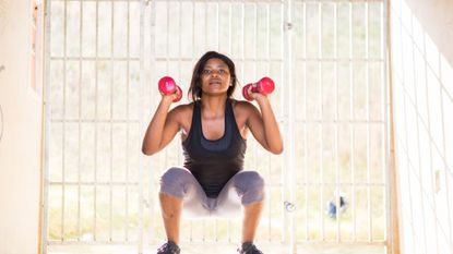 Woman performing a dumbbell squat