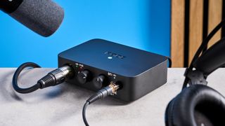 the rode ai-1 audio interface in black with an XLR input, a headphone input, and 2 speaker outputs