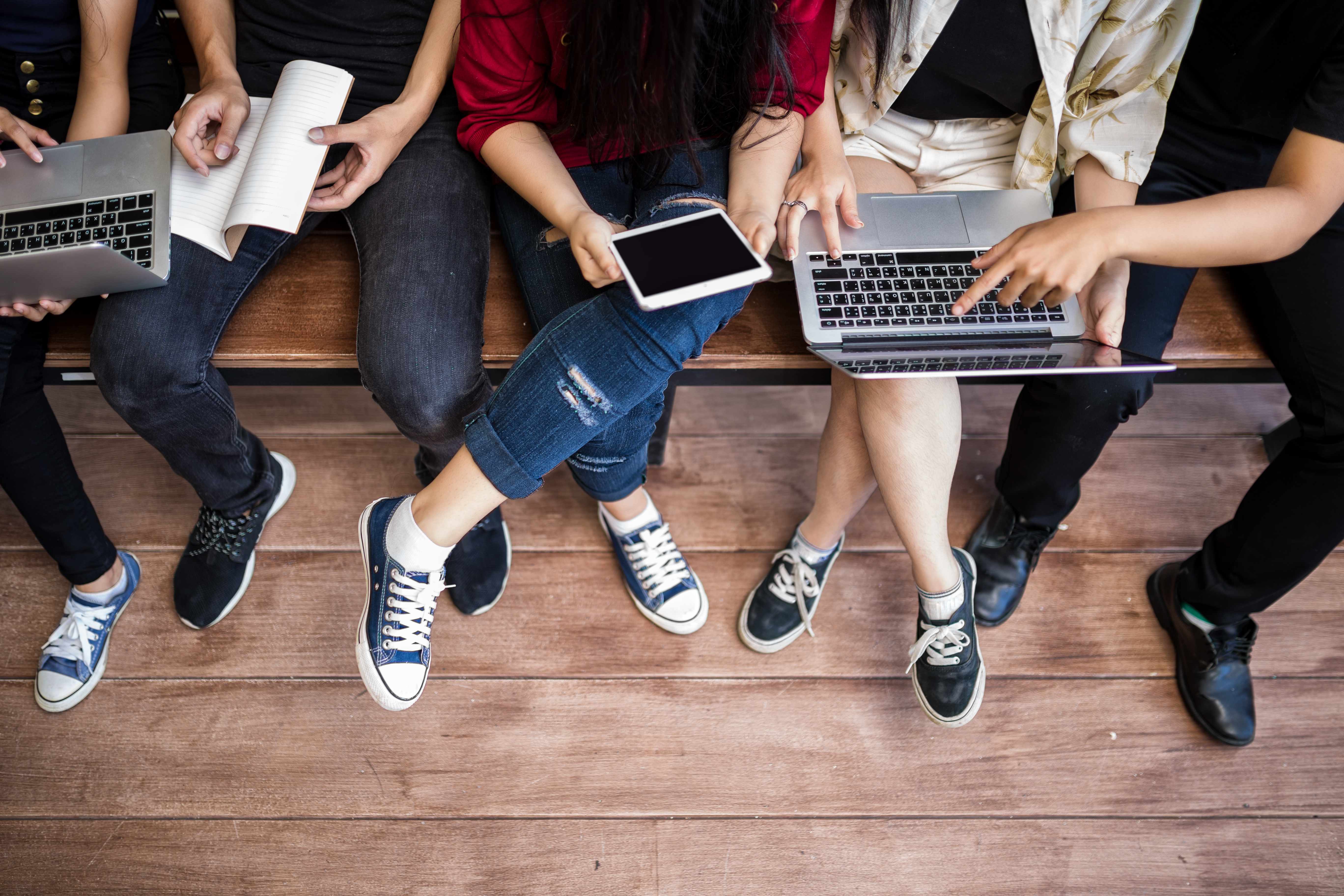 A photo of college students with laptops and tablets