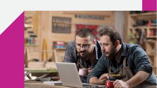 Whitepaper cover with two men in a workshop both looking at a laptop