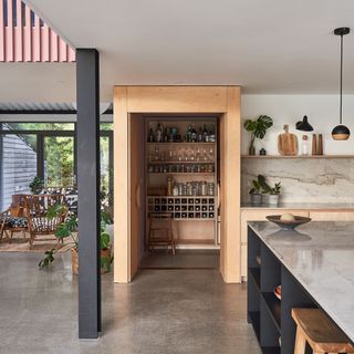 kitchen with open pantry and white marble top surfaces