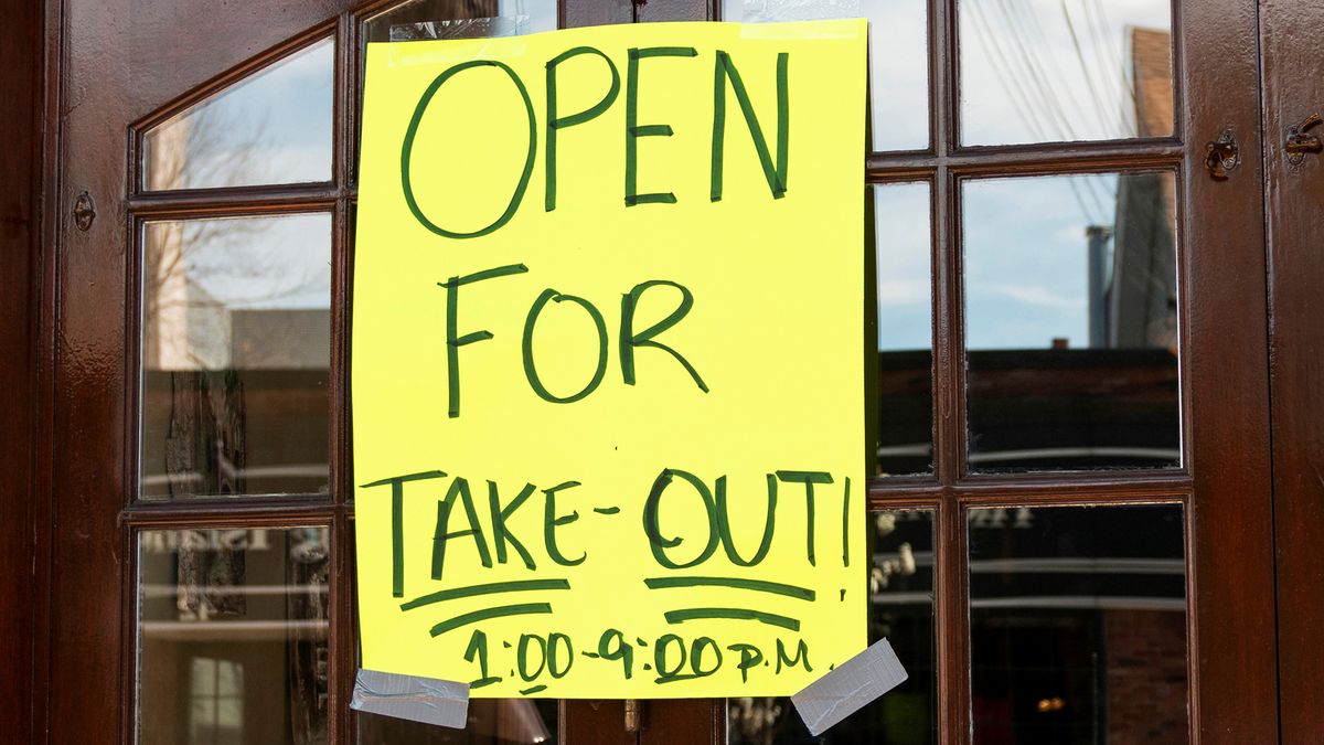 A restaurant sign reads &quot;Open For Take-Out&quot; during the COVID-19 pandemic.