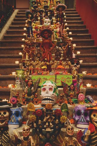 Day of the Dead decorations on steps, amid candles