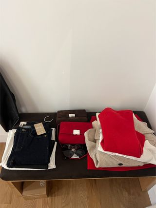 A stack of clothing items in the dressing room at Madewell's new SoHo store.