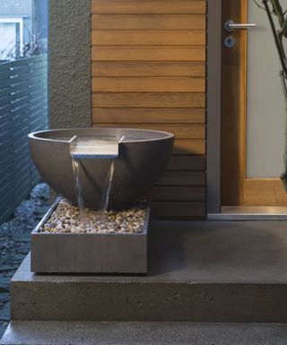 A contemporary water feature in a no-plant front yard