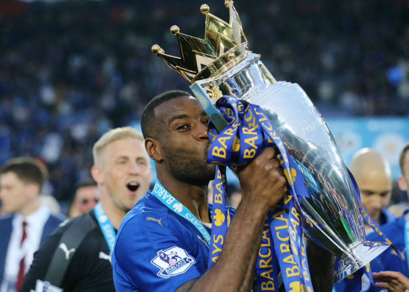 Wes Morgan kisses the Premier League trophy