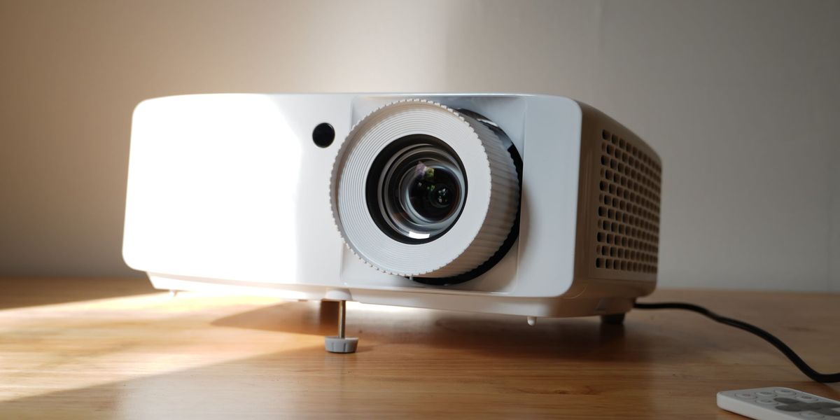 Optoma UHZ66 projector on table