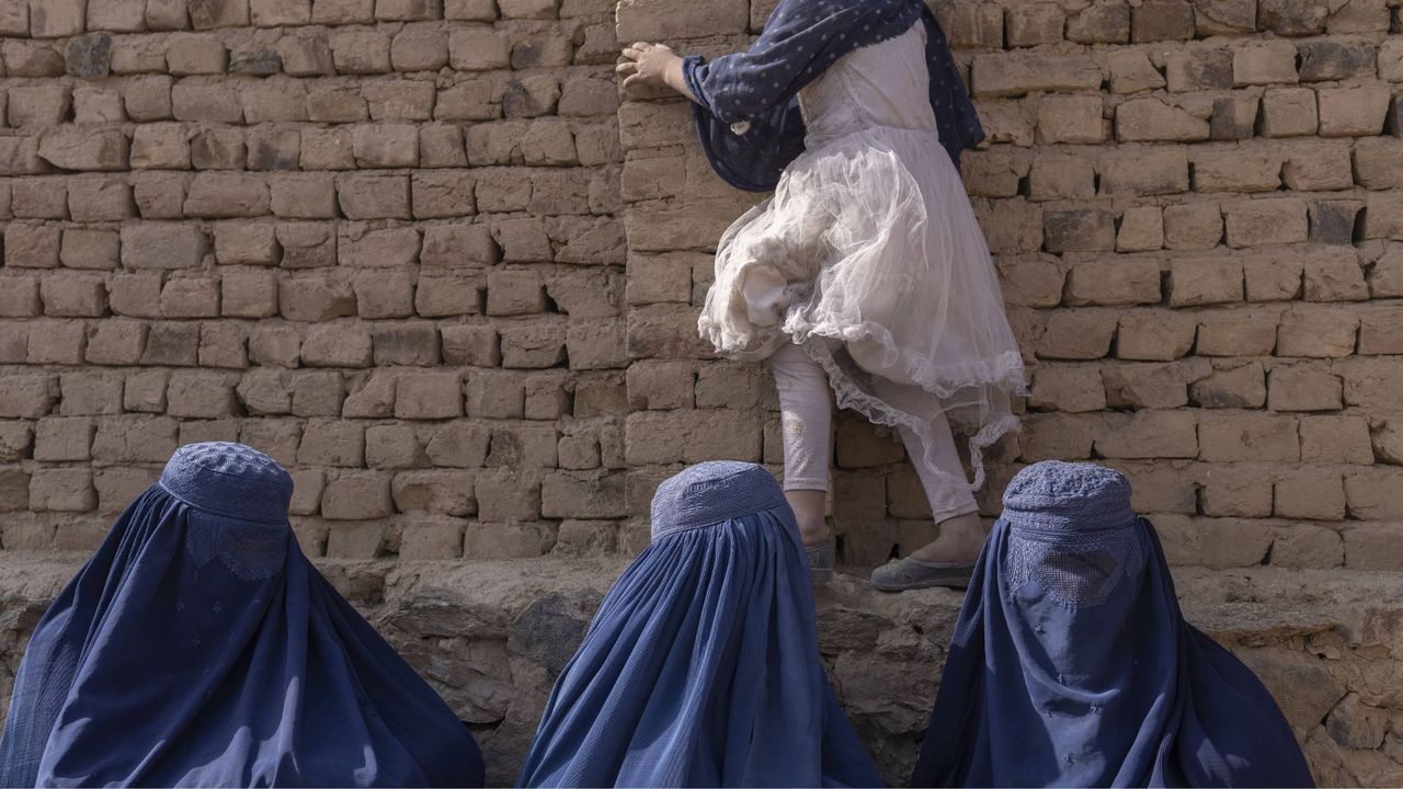 Afghan women wait to see a doctor at a mobile health clinic in Bagrami District, Kabul Province, Afghanistan