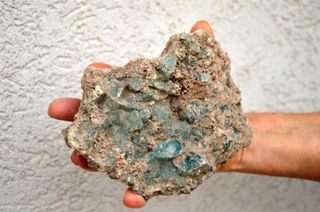 This lump of debris from a glass kiln was once of many pieces of glass in various stages of production found in the refuse pit.
