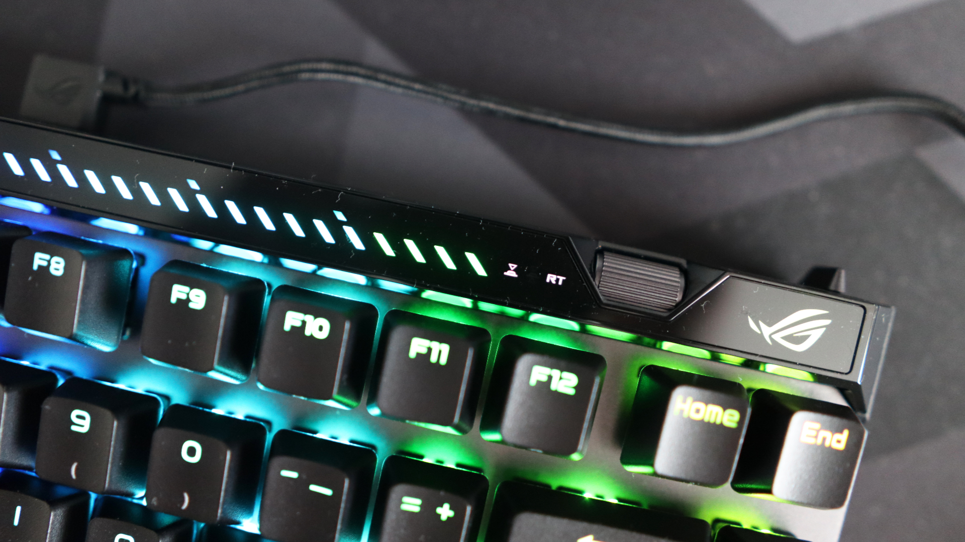 The Asus ROG Falchion Ace 75 HE on a desk with the lighting enabled.