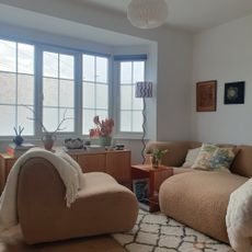 The living area in my studio flat with my modular King Living 1977 sofa and Habitat sideboard placed in my bay window