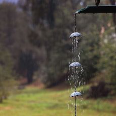 Close up of metal rain chain with umbrella details