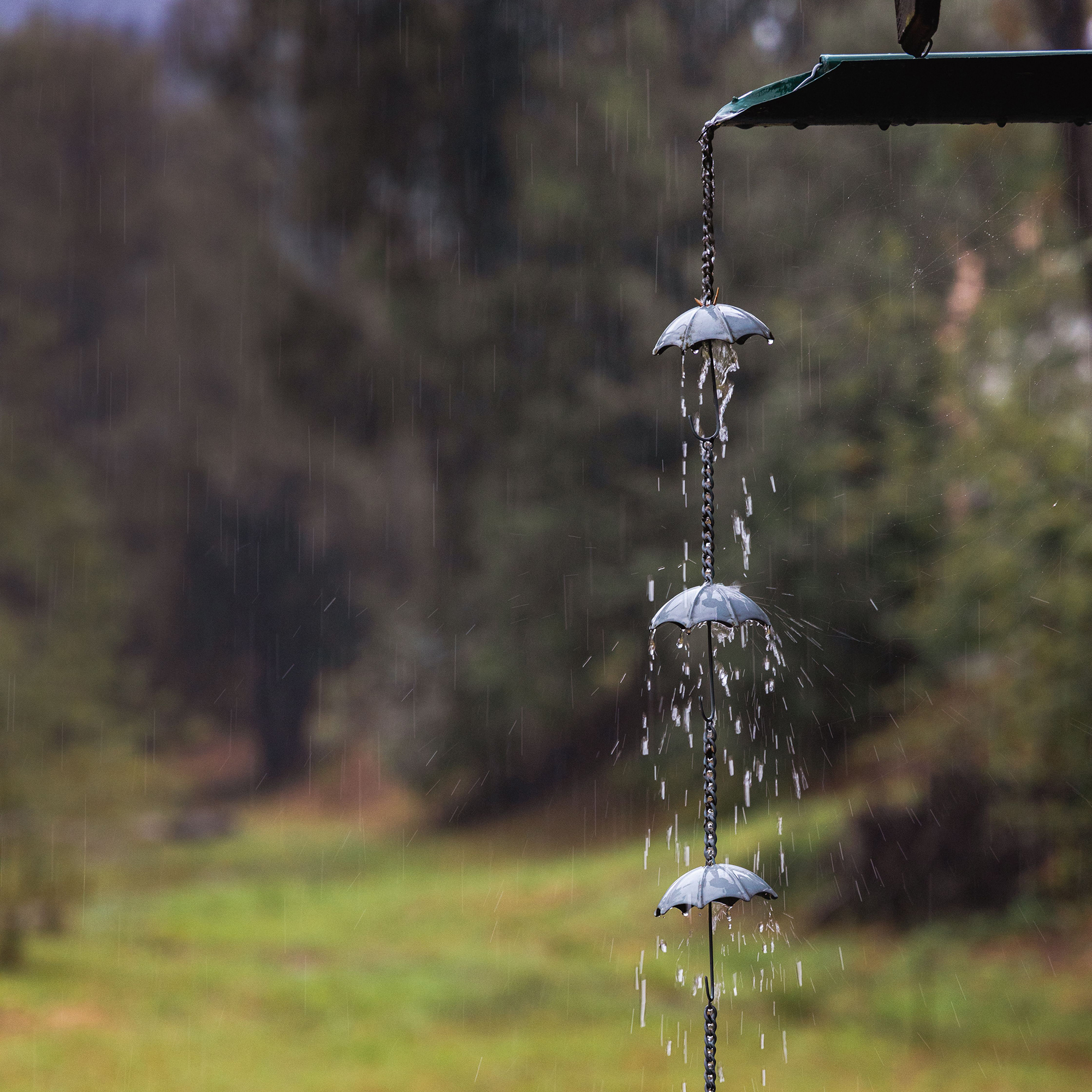 Close up of metal rain chain with umbrella details