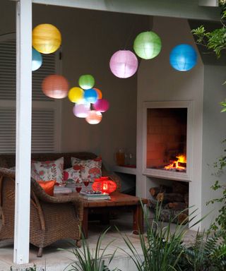 colorful lanterns in patio cover with fireplace
