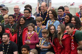 Catherine, Princess of Wales, Prince William, Prince of Wales, Prince George of Wales, Prince Louis of Wales and Princess Charlotte of Wales pose for a group pictures with volunteers who are taking part in the Big Help Out, during a visit to the 3rd Upton Scouts Hut in Slough