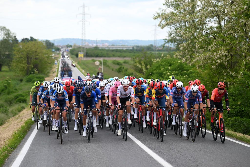 FOSSANO ITALY MAY 06 LR Pieter Serry of Belgium and Team Soudal QuickStep Lorenzo Germani of Italy and Team Groupama FDJ Tadej Pogacar of Slovenia and UAE Team Emirates Pink Leader Jersey Mikkel Bjerg of Denmark and UAE Team Emirates Amanuel Ghebreigzabhier of Eritrea and Team Lidl Trek Quinten Hermans of Belgium and Team Alpecin Deceuninck and Tobias Foss of Norway and Team INEOS Grenadiers lead the peloton during the 107th Giro dItalia 2024 Stage 3 a 166km stage from Novara to Fossano 374m UCIWT on May 06 2024 in Fossano Italy Photo by Dario BelingheriGetty Images