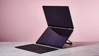 Three-quarter view of ASUS ROG Zephyrus Duo 2026 on a desk with pink wall in background
