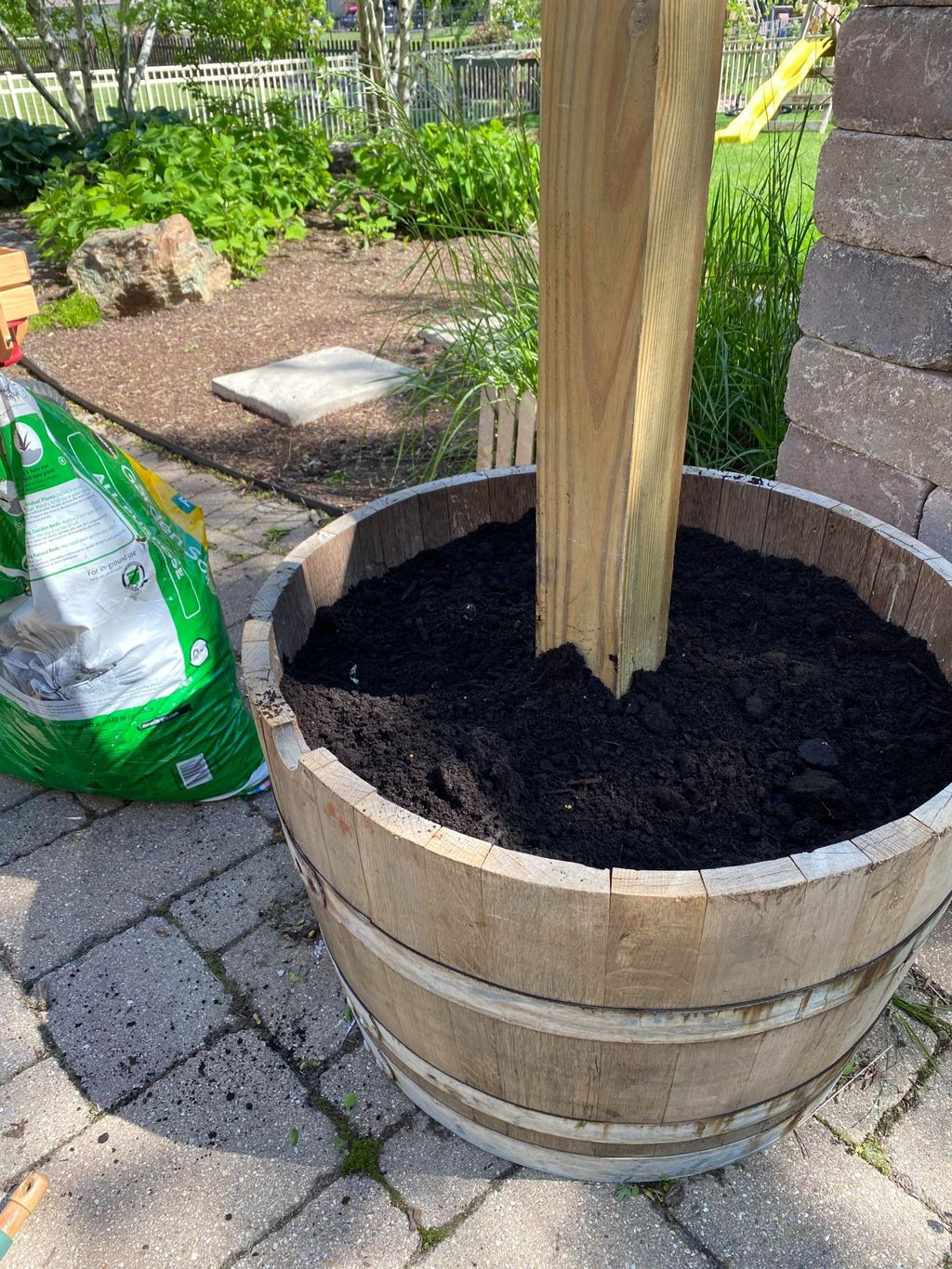 A clever, inexpensive barrel planter DIY transformed this patio space