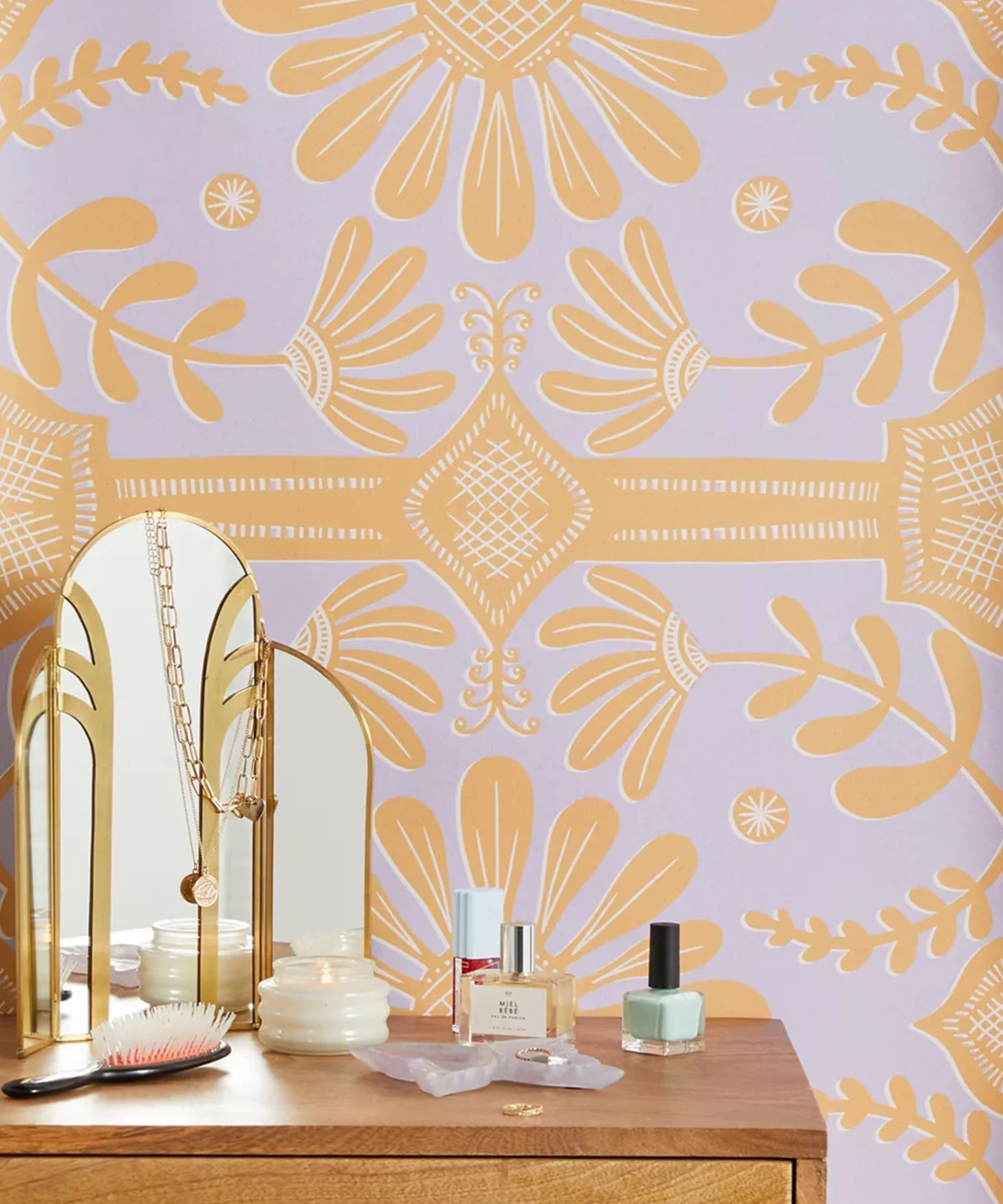 Lilac and orange patterned wallpaper behind a vanity