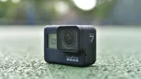 The GoPro Hero 7 Black sitting on a tarmac surface