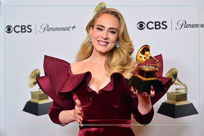Adele holding Grammy award