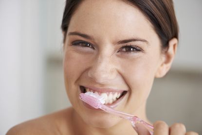 Woman brushing teeth