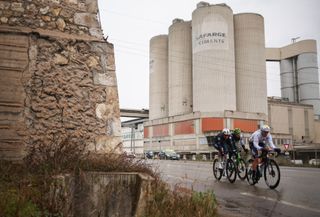 Groupama-FDJ's French rider Remi Cavagna, Caja Rural-Seguros RGA's Czech rider Jakub Otruba and TotalEnergies' French rider Thomas Gachignard cycle in a breakaway past a Lafarge cement plant during the 6th stage of the Paris-Nice cycling race, 209,8 km between Saint-Julien-en-Saint-Alban and Berre lâ€™Ã‰tang, on March 14, 2025. (Photo by Anne-Christine POUJOULAT / AFP)