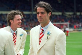 Jamie Redknapp and Steve McManaman of Liverpool on the pitch at Wembley ahead of the 1996 FA Cup final against Manchester United, wearing their infamous cream suits