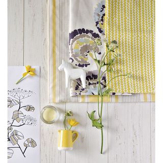 white flooring with yellow flower in jug and white horse