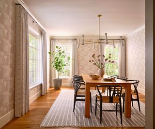 dining room with geometric wallpaper and wooden table