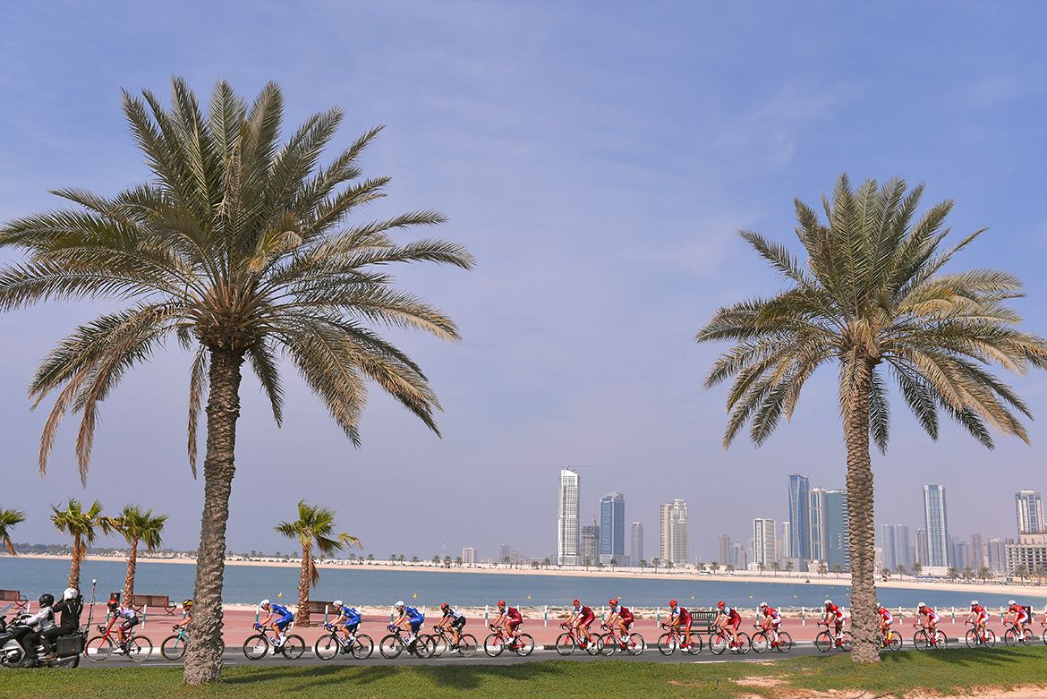 The peloton races agains the Dubai skyline.