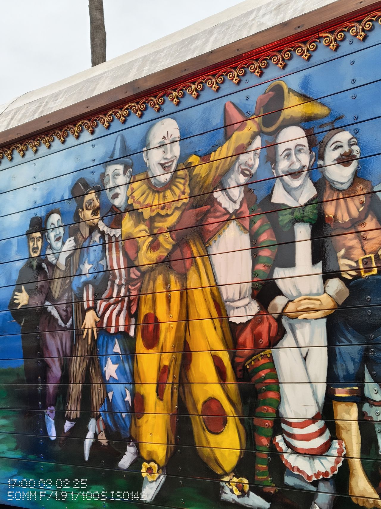A mural of circus performers on the side of a truck