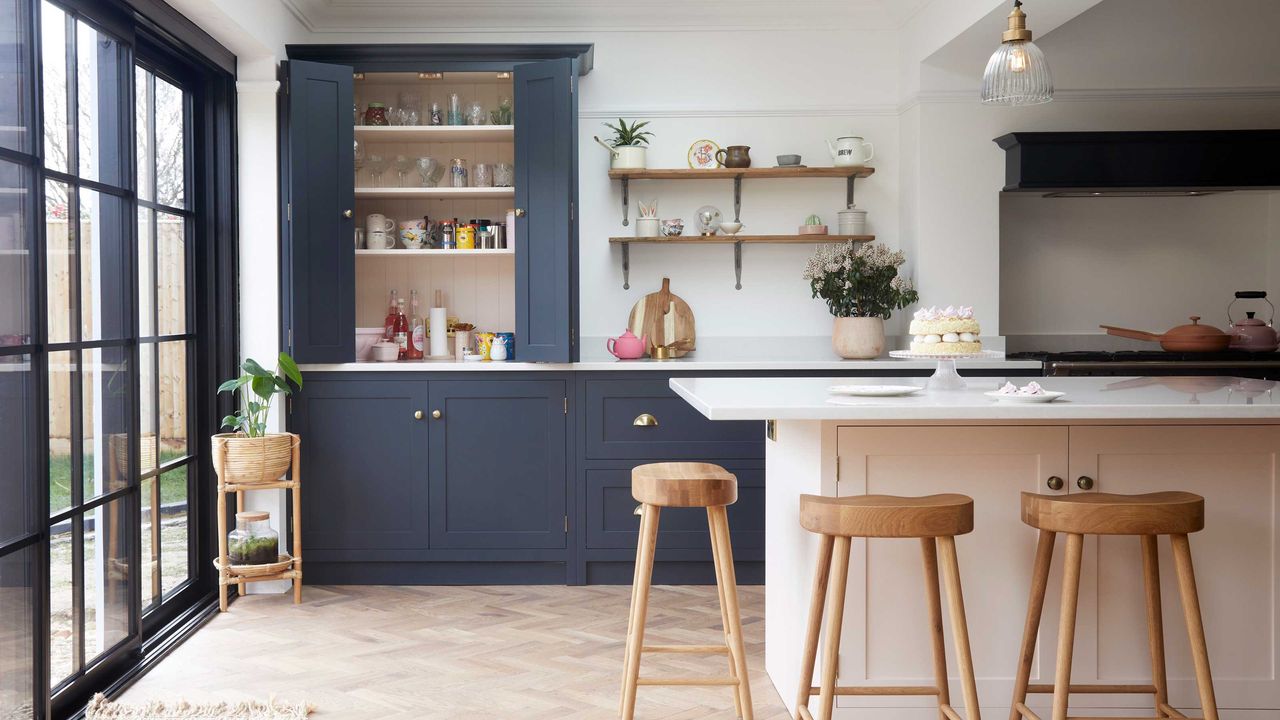 Blue Shaker kitchen with large white kitchen island with marble worktop and open kitchen shelving