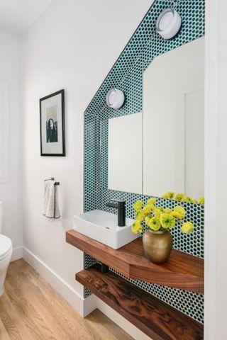 A bathroom with shelving pushed into the wall