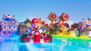 The cast of The Super Mario Bros. Movie riding Mario Karts on Rainbow Road.
