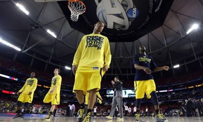 The Michigan Wolverines warm up for their NCAA championship game against the Louisville Cardinals.