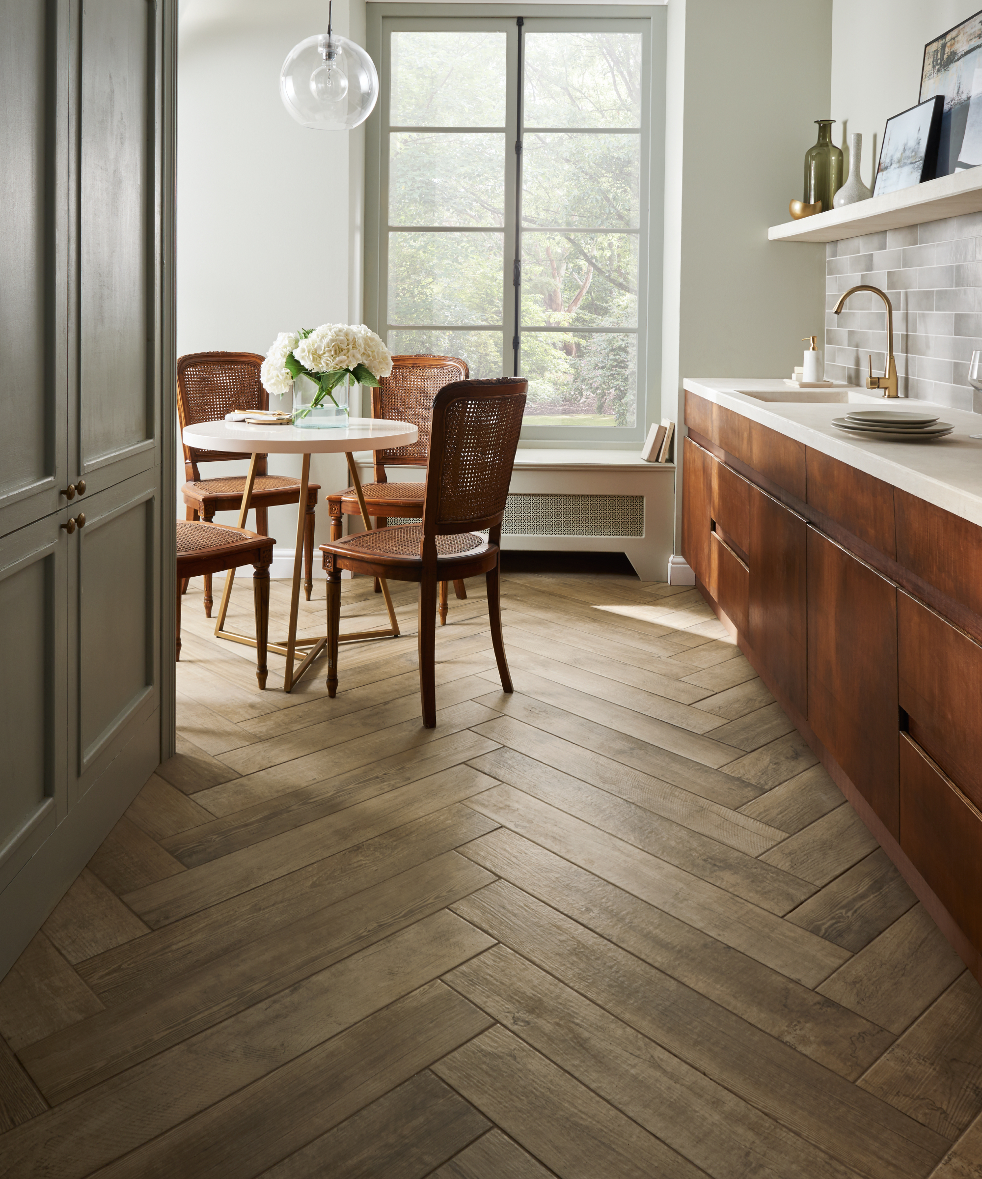 Mora Oak parquet-style tiles in kitchen with copper units by Topps Tiles