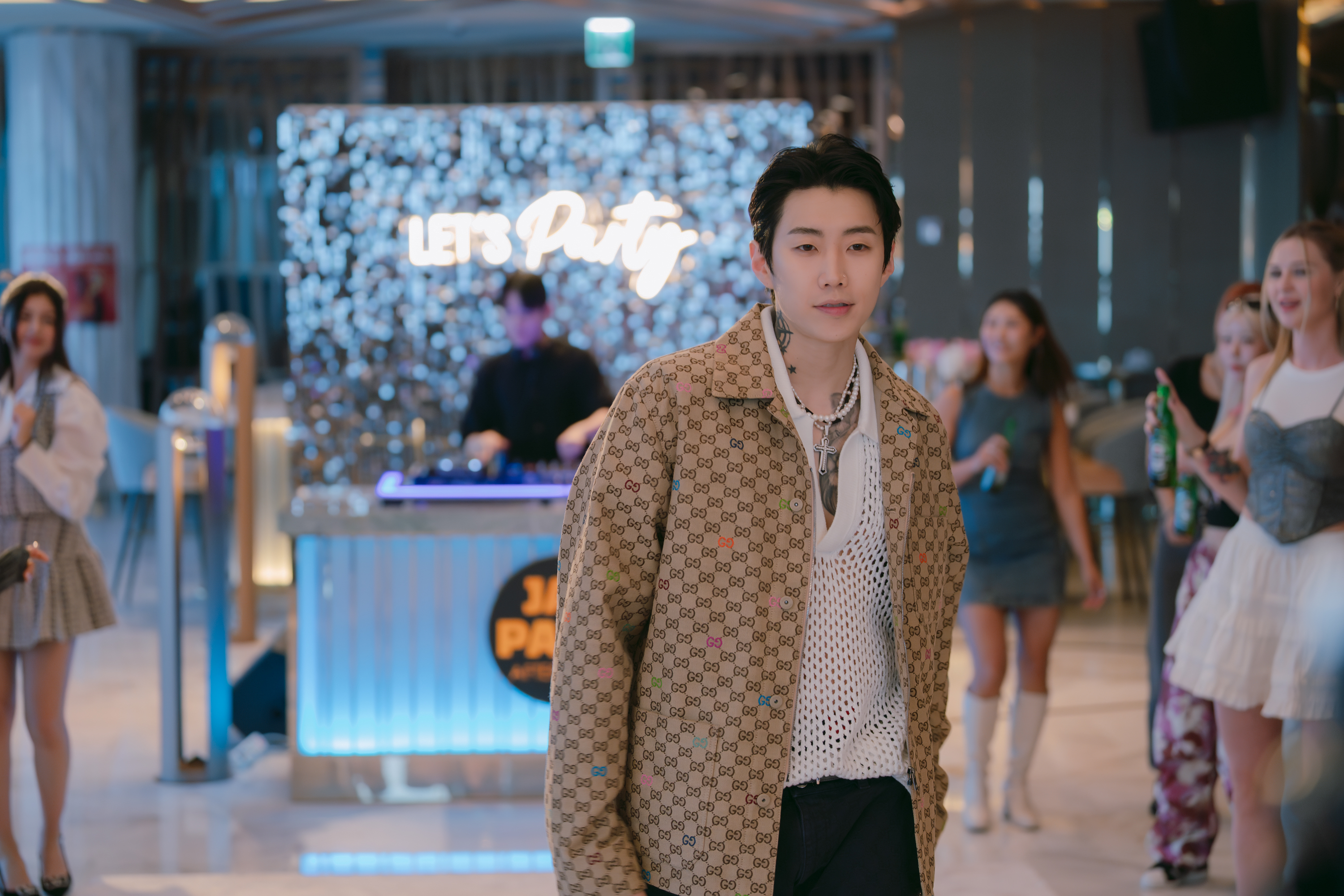 Korean rapper Jay Park stands in the middle of the dance floor at a party, in the Netflix K-drama 'Boyfriend on Demand.'