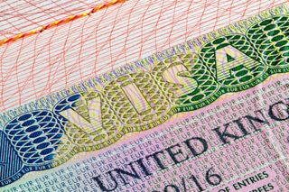 A close up of a UK visa in a passport