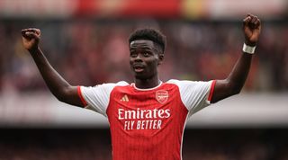 LONDON, ENGLAND - SEPTEMBER 24: Bukayo Saka of Arsenal celebrates after scoring his teams first goal during the Premier League match between Arsenal FC and Tottenham Hotspur at Emirates Stadium on September 24, 2023 in London, England. (Photo by Ryan Pierse/Getty Images)