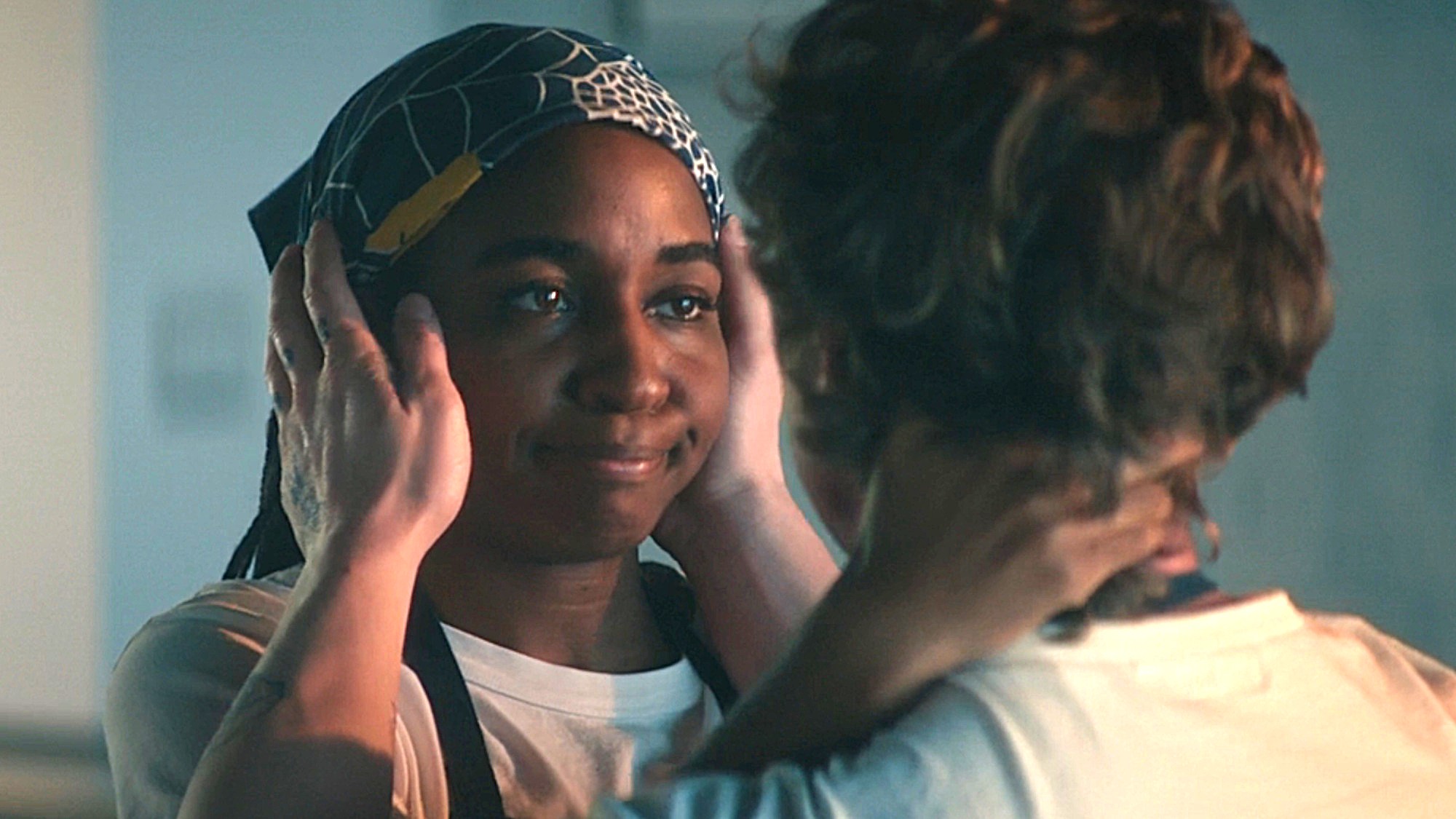 Carmy (Jeremy Allen White) holds Sydney's (Ayo Edebiri) head in his hands on The Bear.