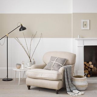white and beige striped living room with armchair