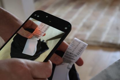 A person taking a photo of a label on a phone