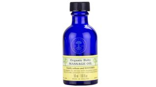 dark blue bottle of Neals Yard baby oil as part of the baby massage oils round up