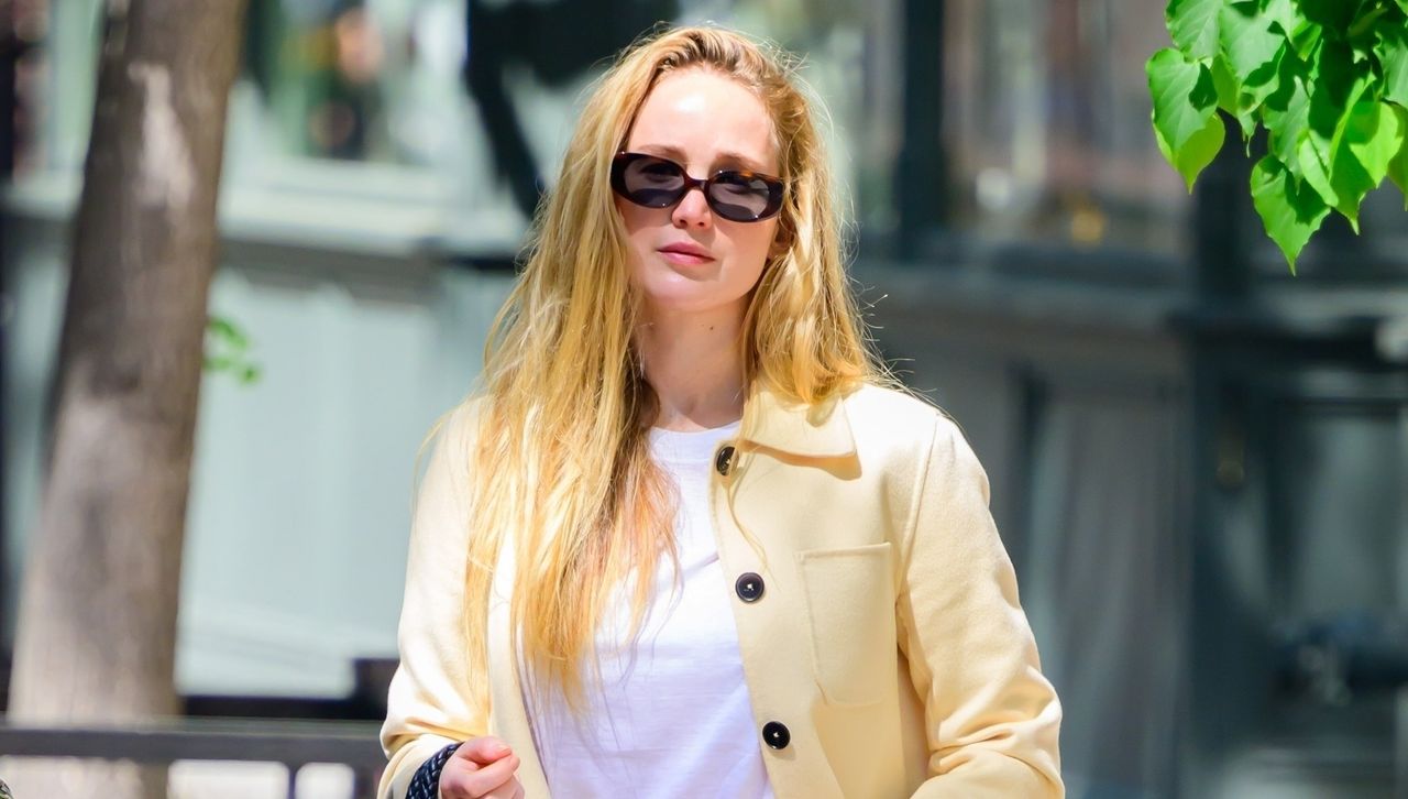 Jennifer Lawrence wears a butter yellow jacket and a white t-shirt plus the mesh flats trend