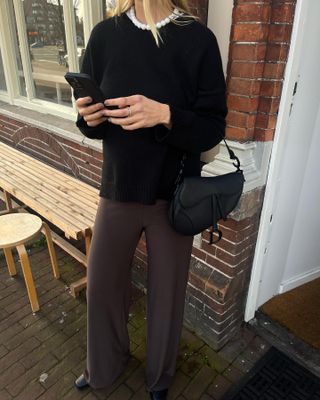 Model and fashion influencer Linda Tol on the street in Europe wearing a chic fall outfit styled with a beaded necklace.